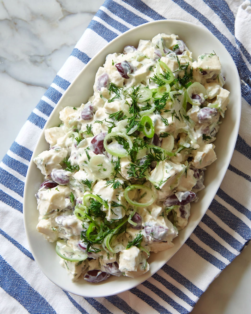 A white plate with a salad on it.