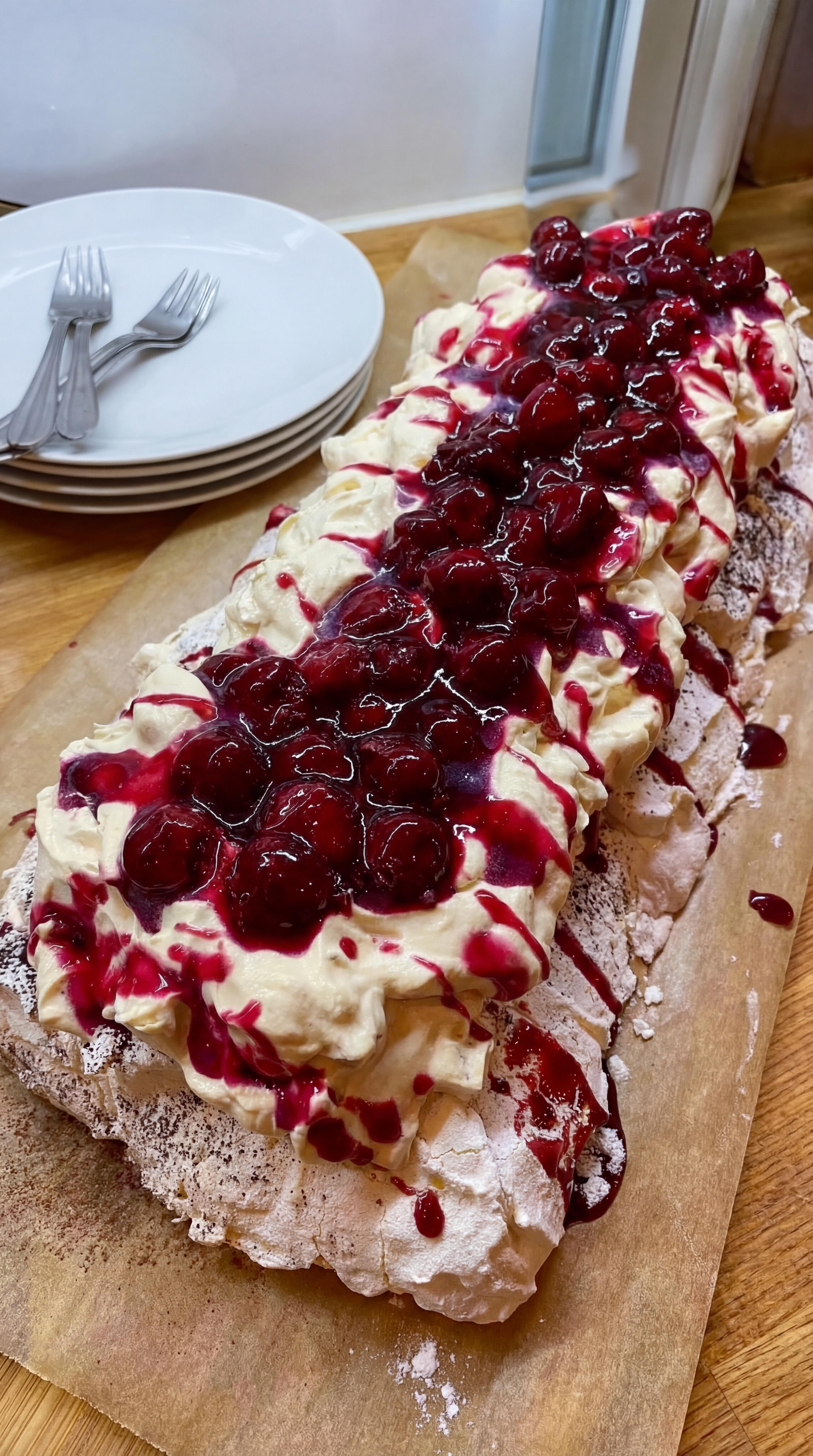 A dessert with berries and whipped cream.