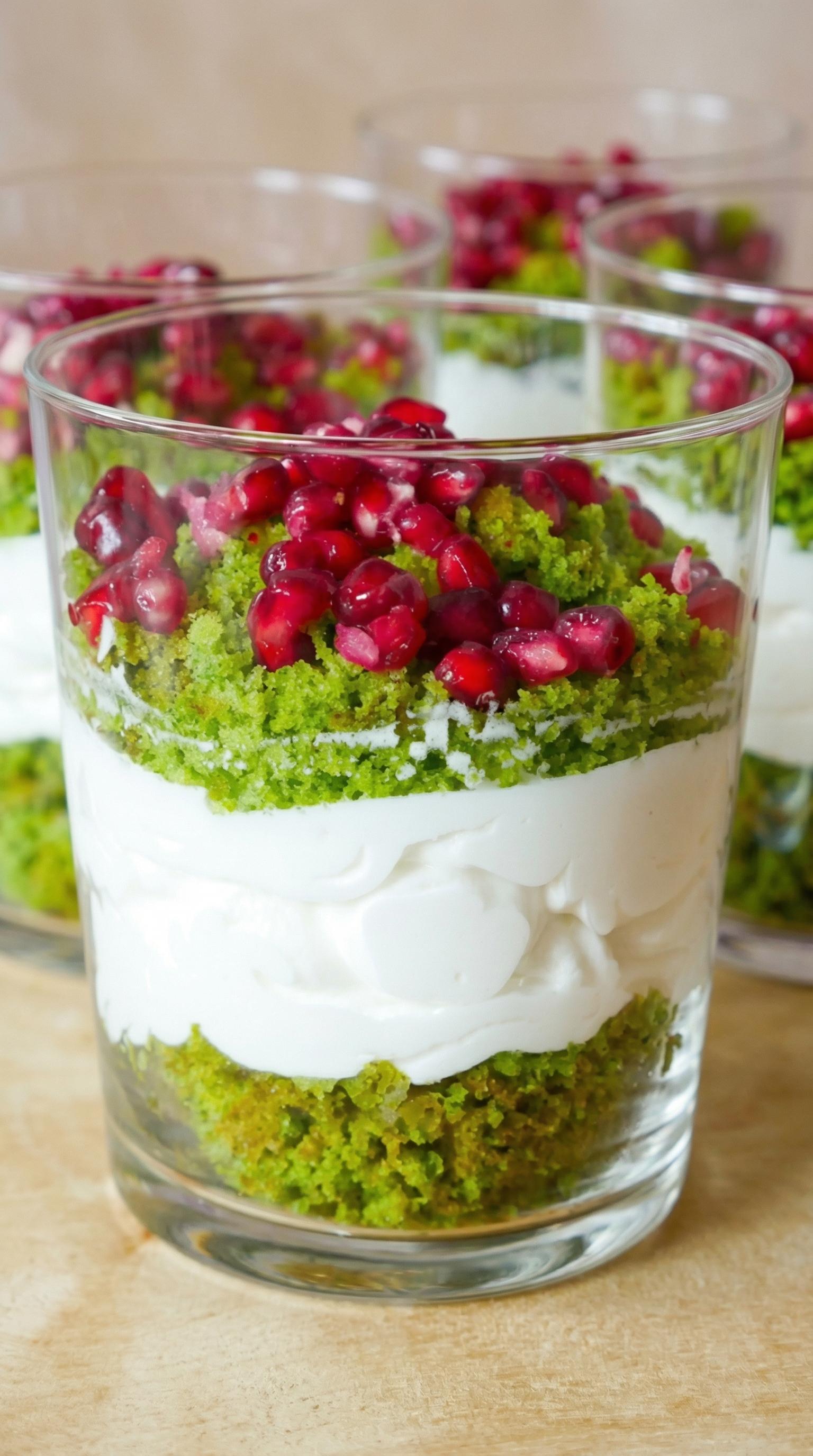 A glass of food with a green topping.