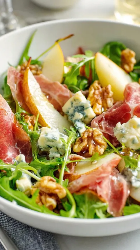 A salad with ham, apples, and blue cheese.