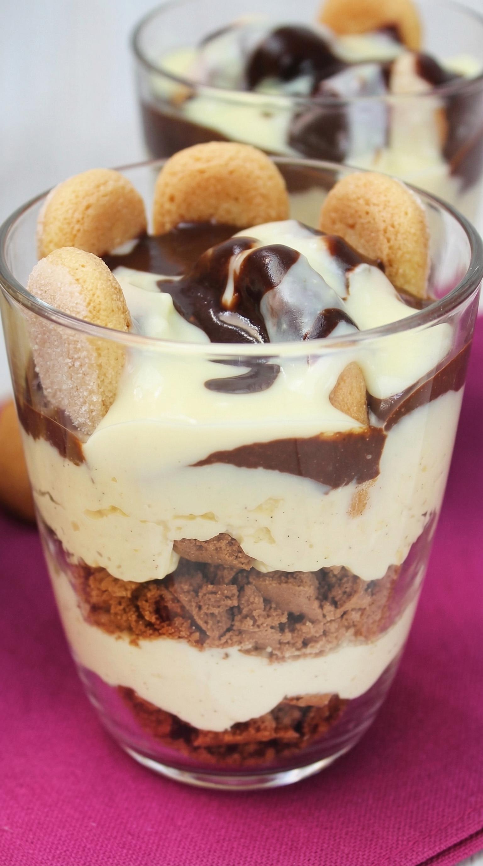 A dessert in a glass with cookies and chocolate.