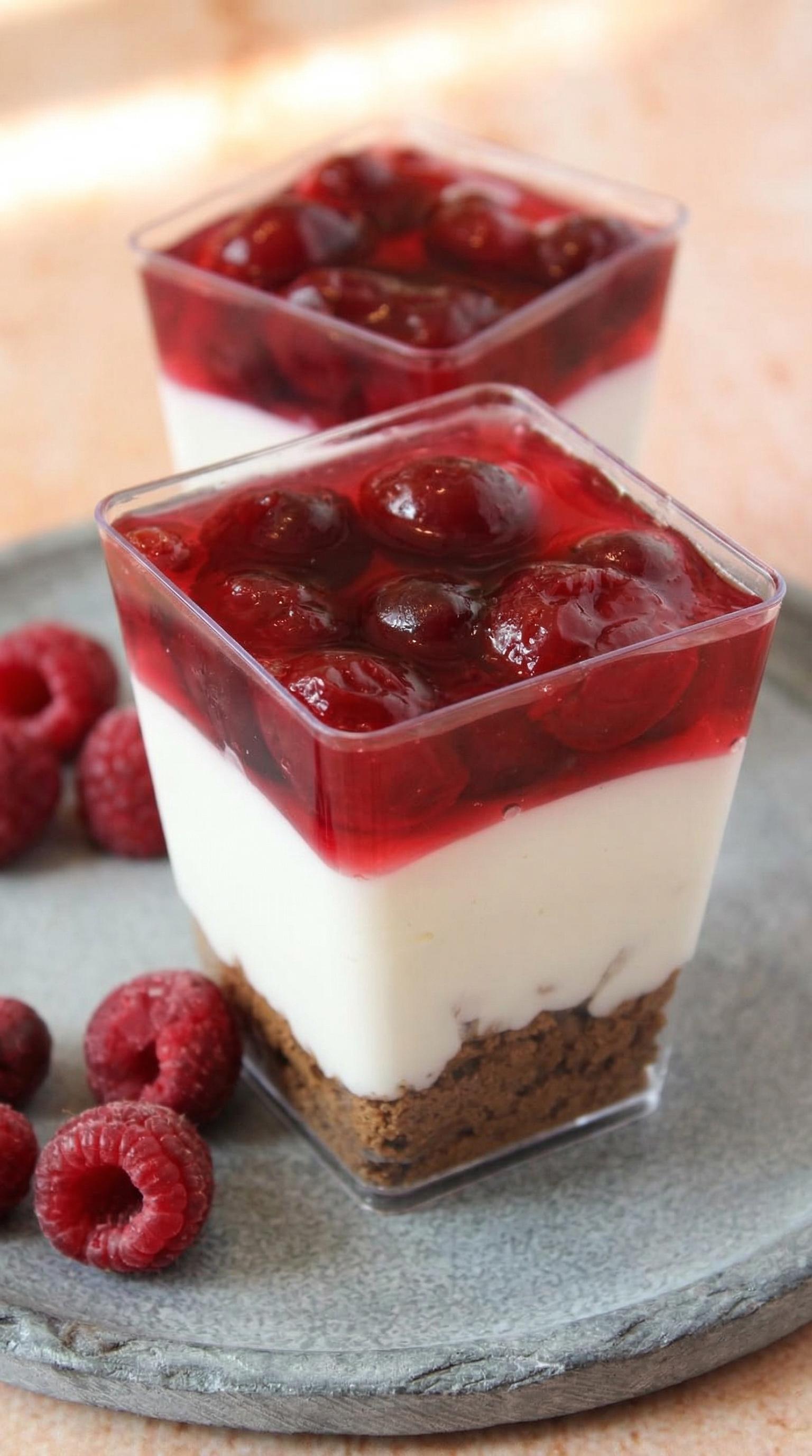 A dessert with white cream and red berries.