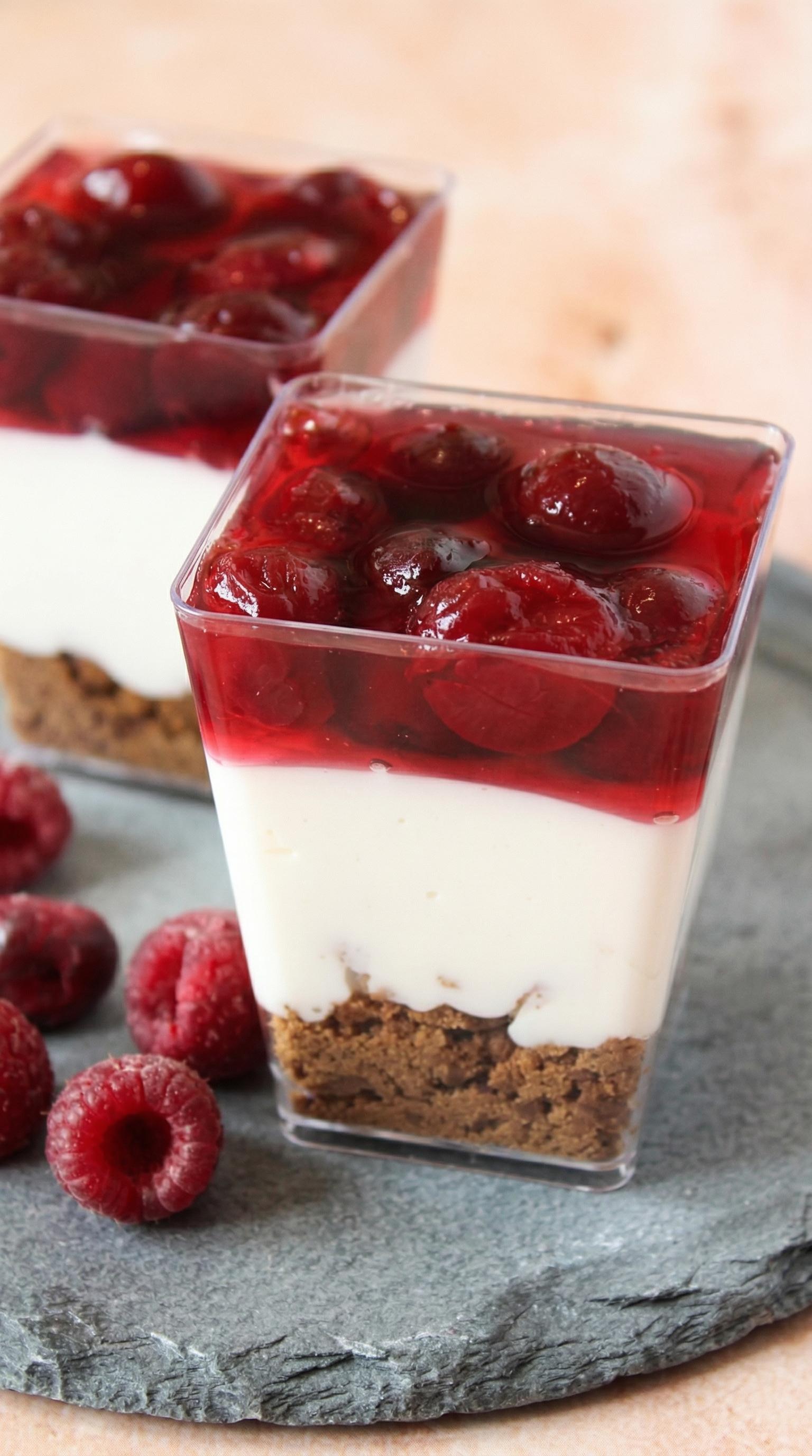 A square glass container with a dessert in it.