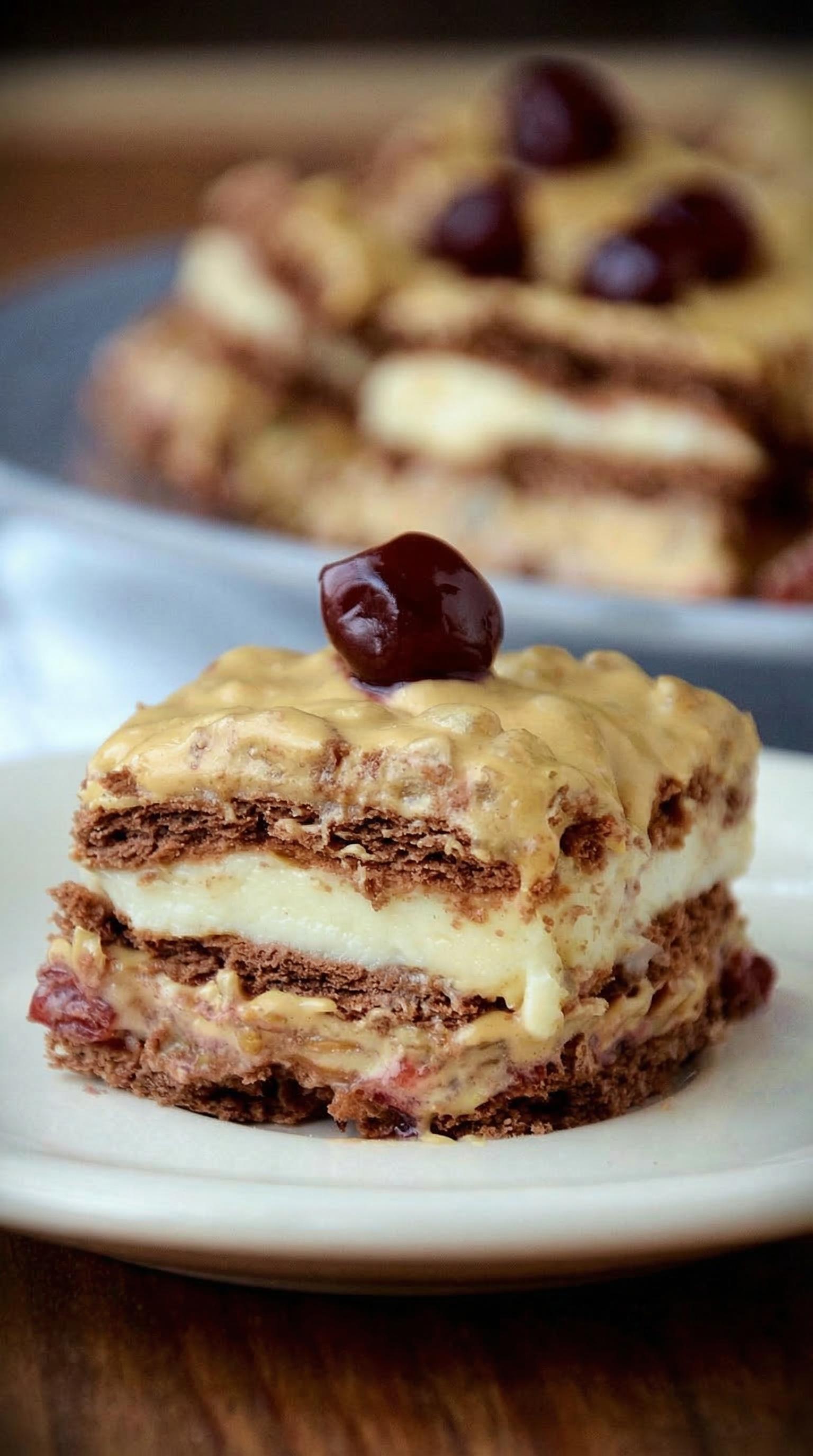 A slice of cake with a cherry on top.