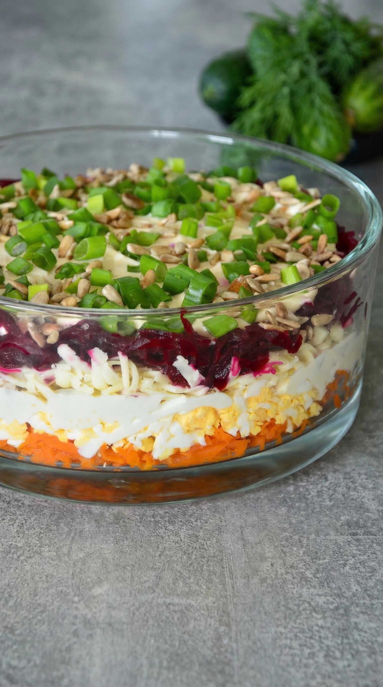 A large bowl of food with a variety of vegetables and nuts.