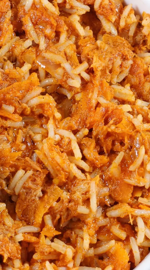 A close up of a dish of rice and meat.
