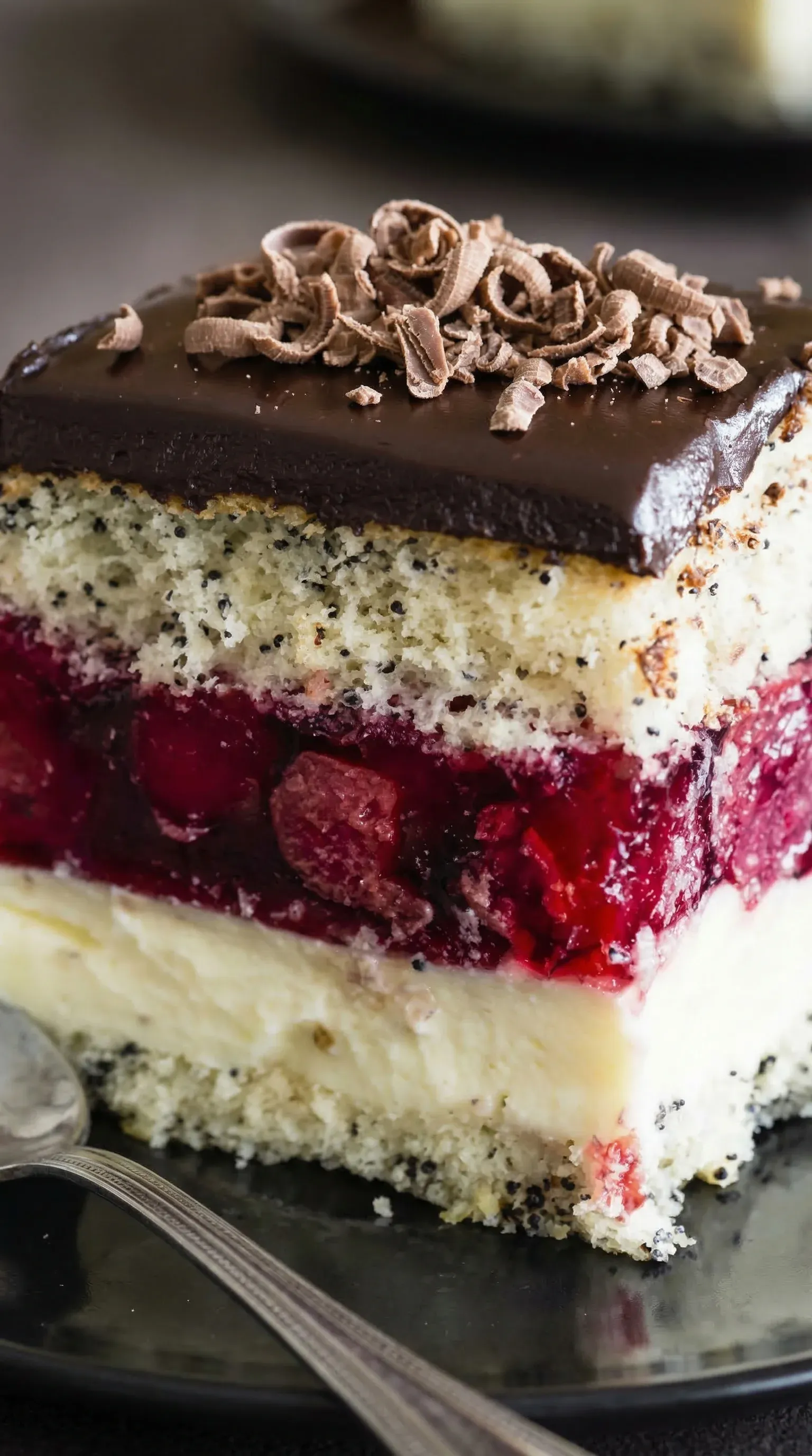 A slice of cake with red berries on top.