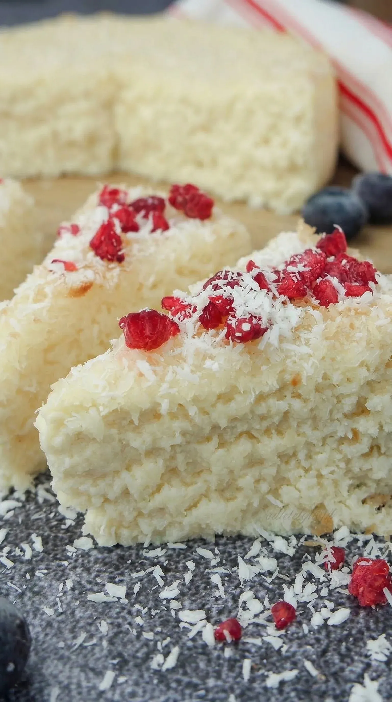 A slice of cake with coconut on top.