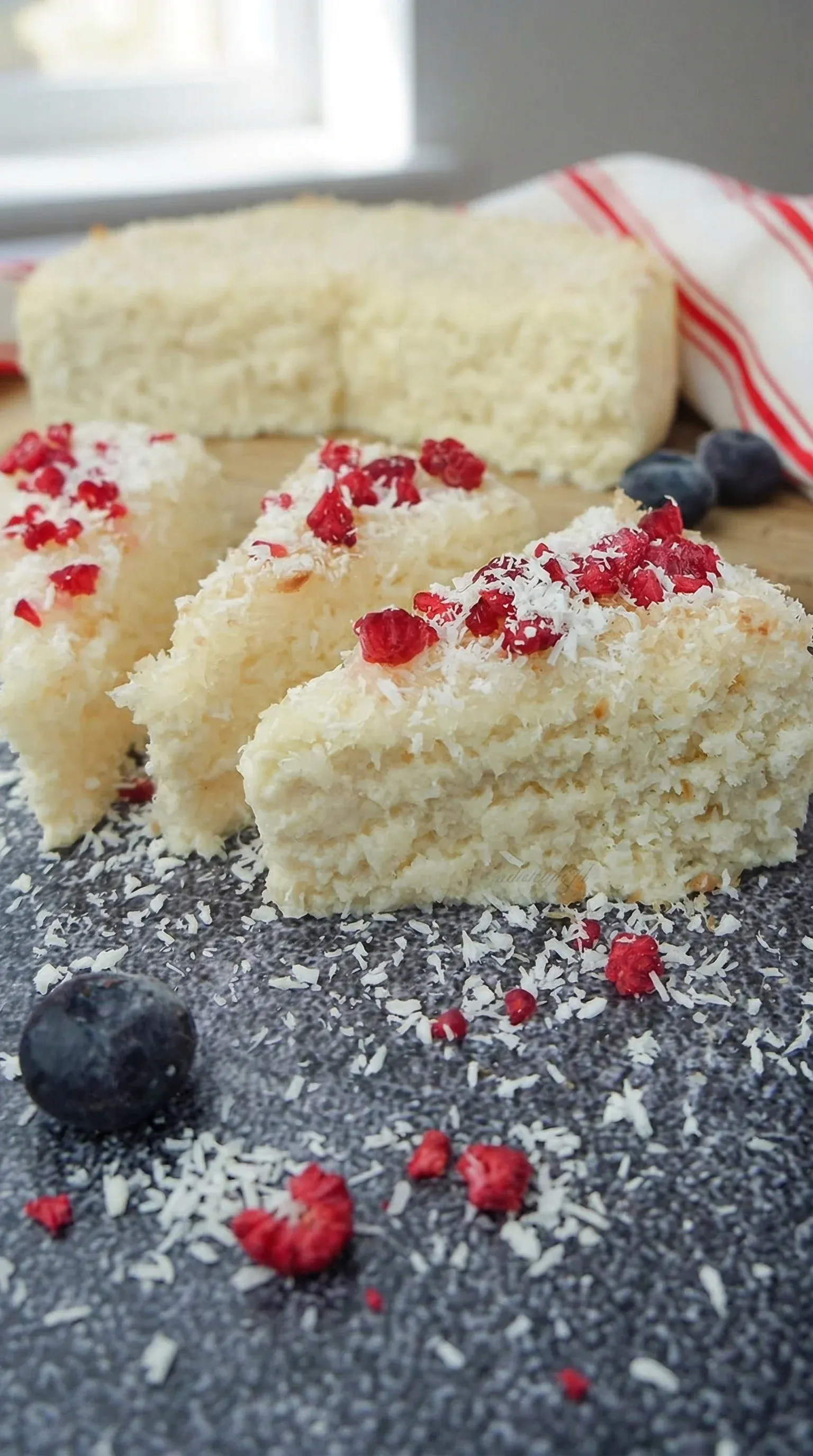 A slice of cake with powdered sugar on top.