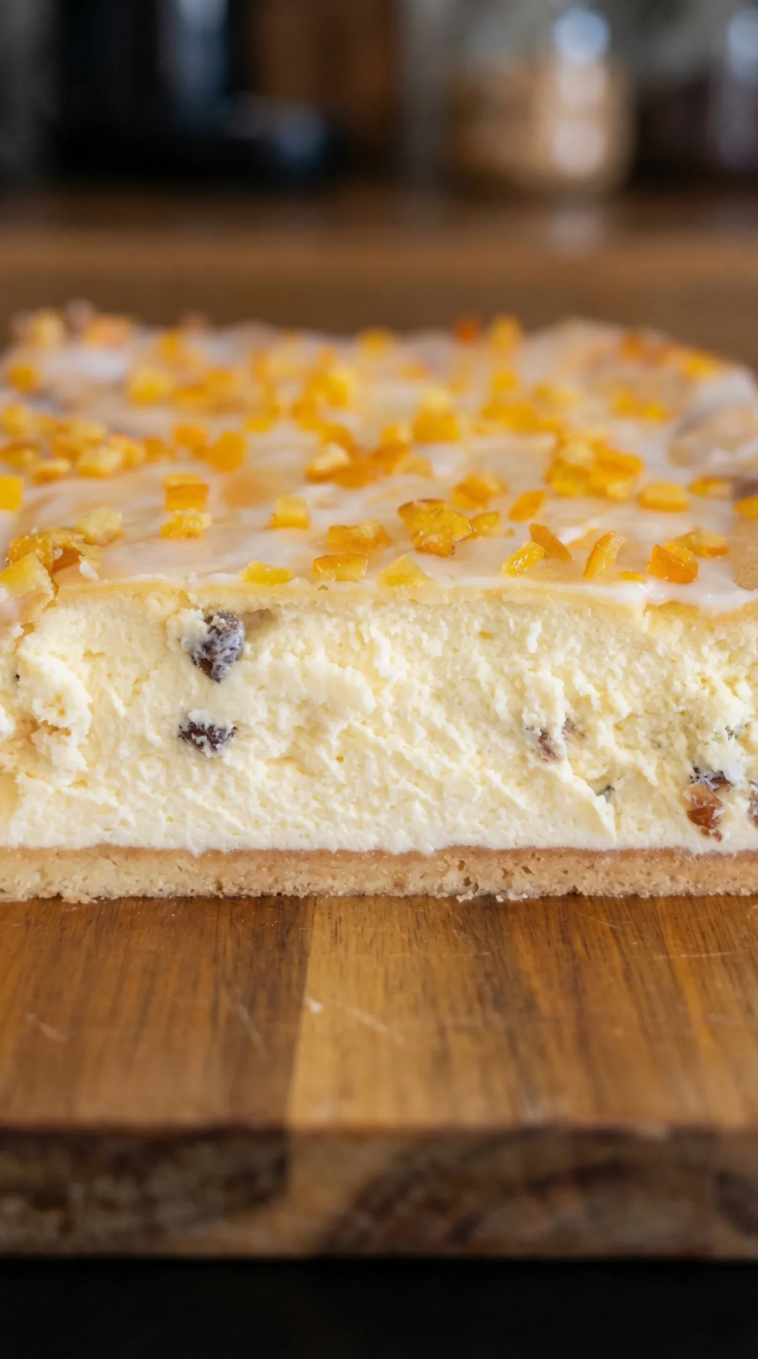 A slice of cake with a zesty orange topping.