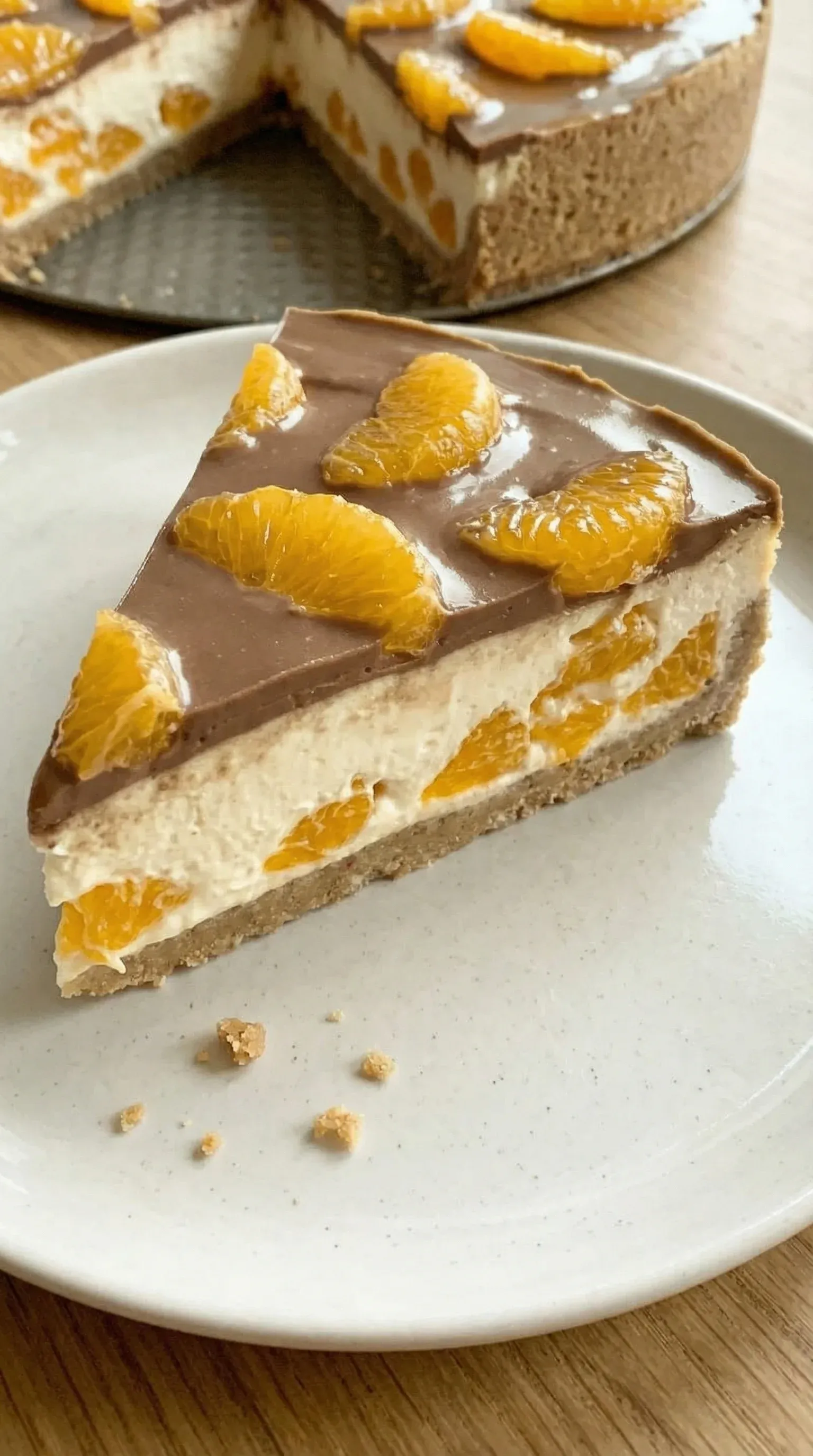 A slice of cake with orange and chocolate toppings.