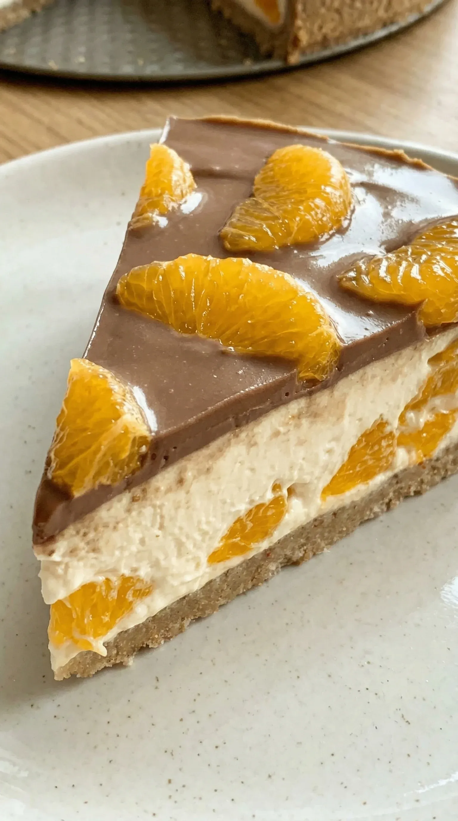 A slice of cake with orange and chocolate toppings.