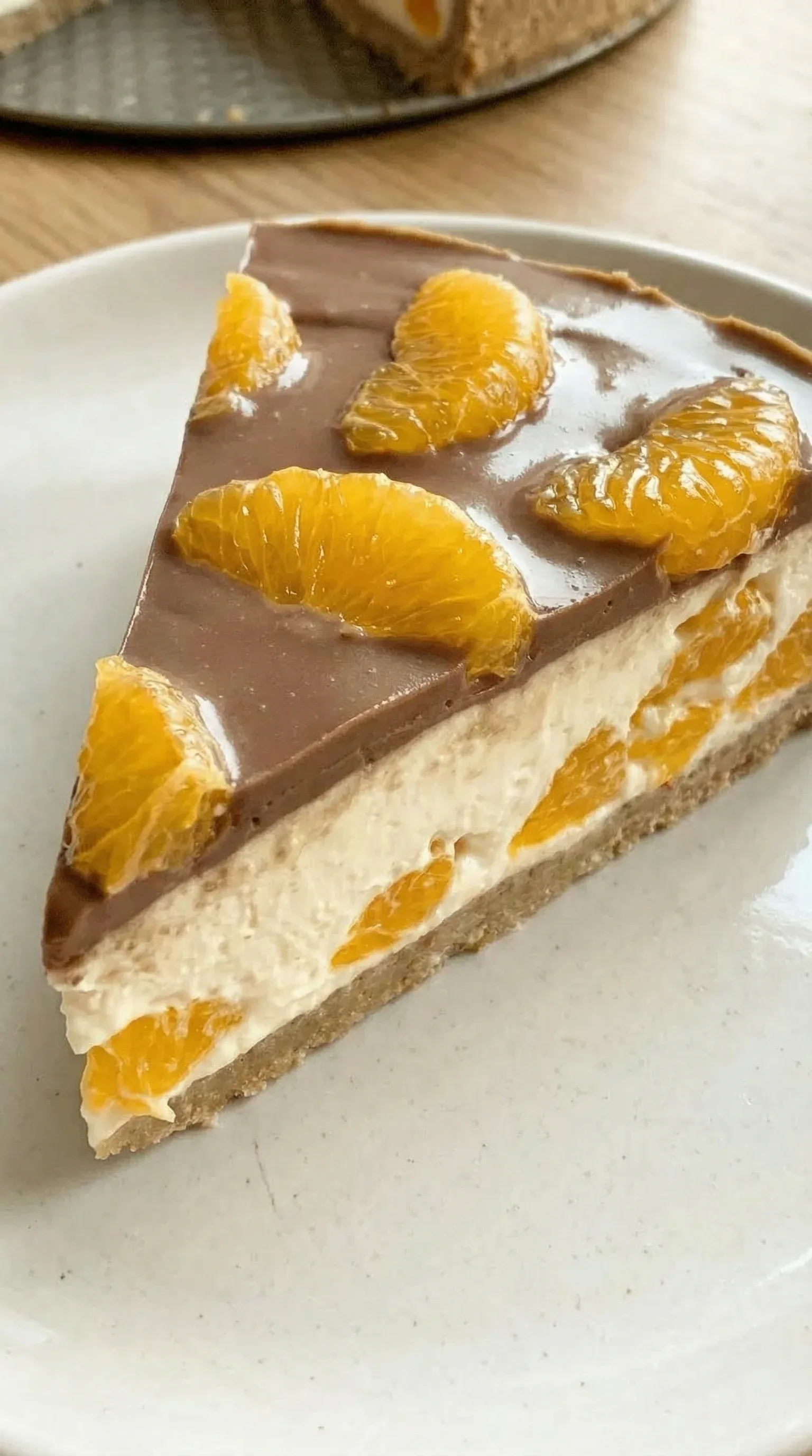 A slice of cake with orange and chocolate toppings.