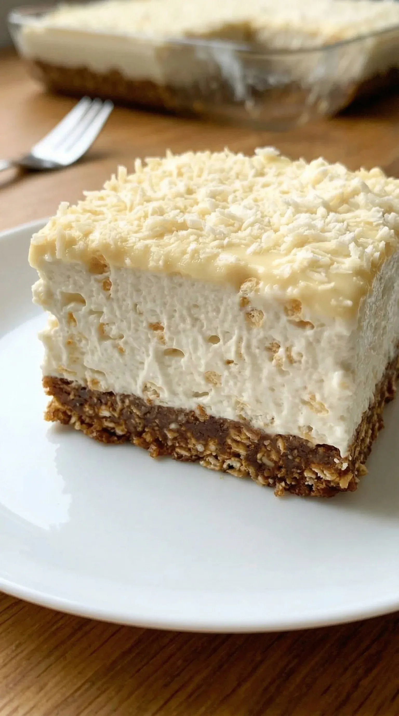 A slice of cake with coconut on top.