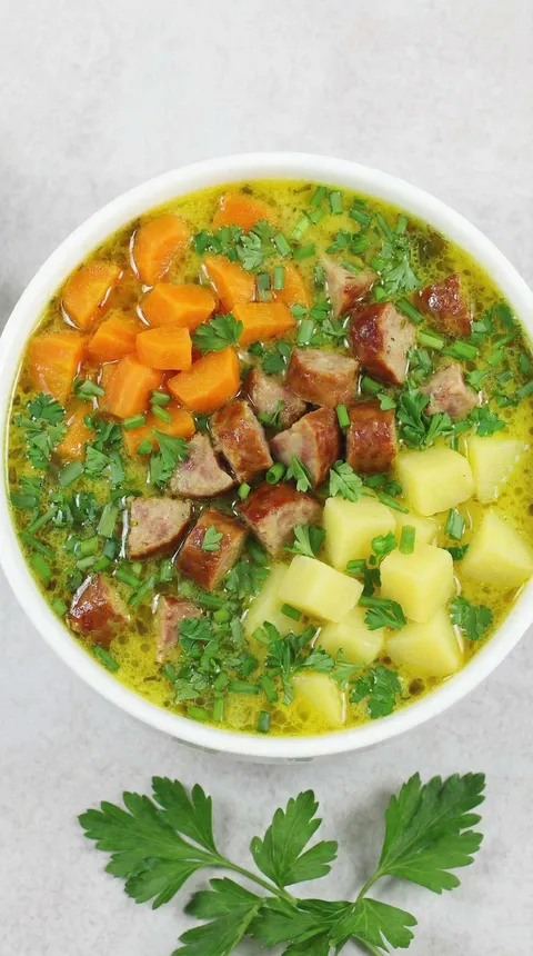 A bowl of soup with meat and vegetables.