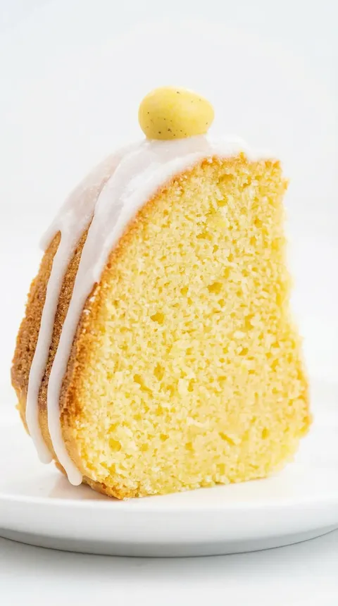 A slice of babka with a yellow frosting.