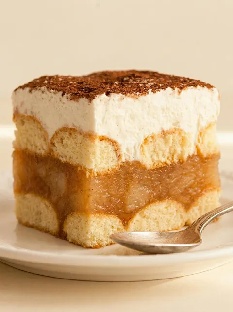 A slice of cake with a spoon on it.