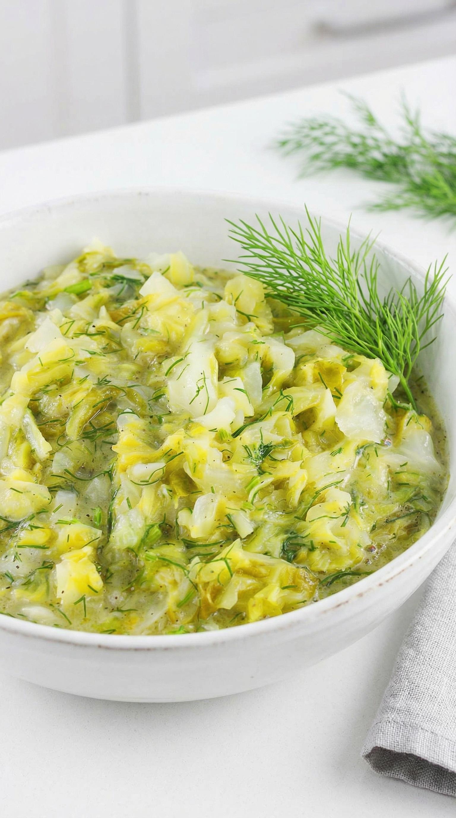 A bowl of food with a green garnish.