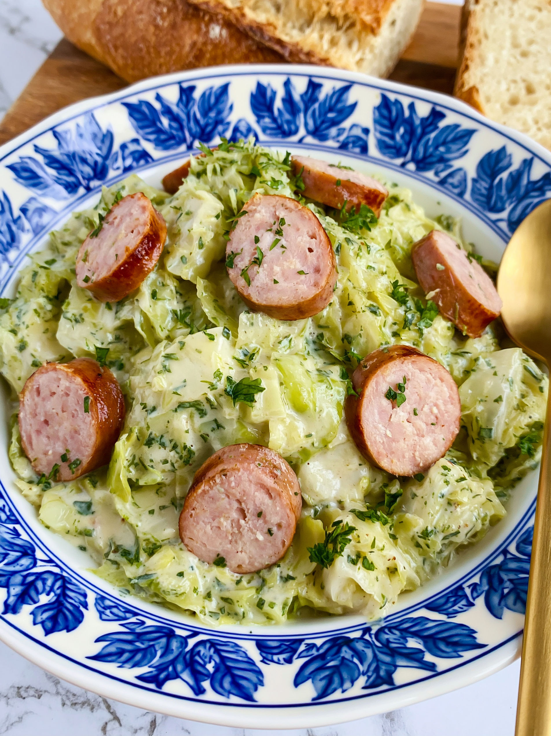 A plate of food with sausage and cabbage.