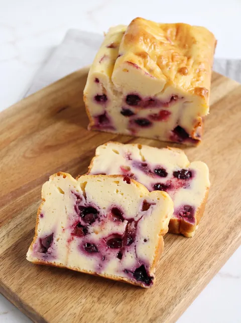 A slice of cake with berries on top.