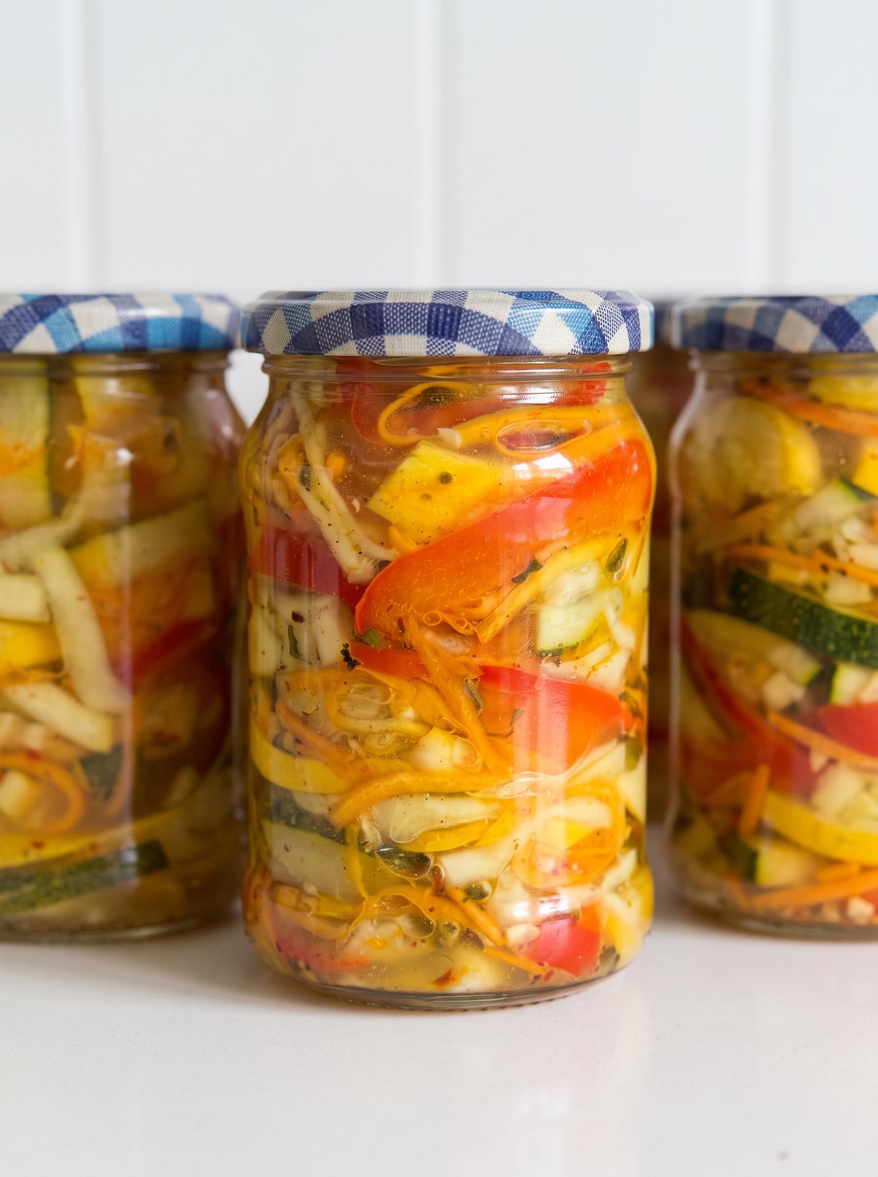 Three jars of pickled vegetables.