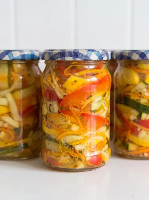 Three jars of pickled vegetables.