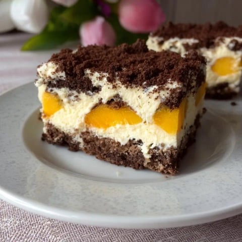 A slice of cake with peaches on top.