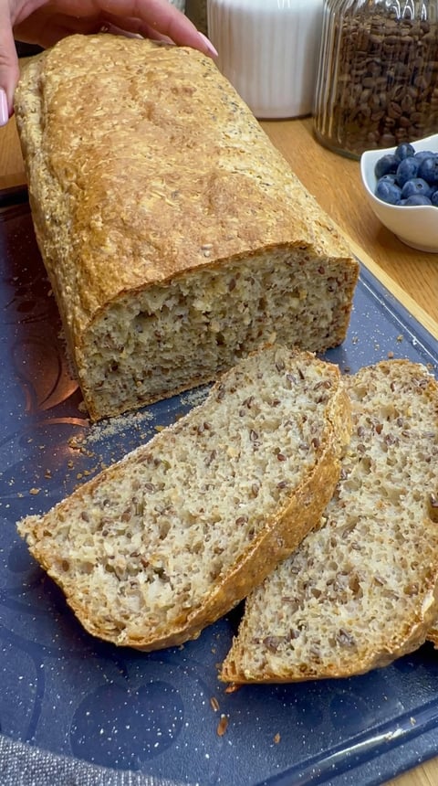 A loaf of bread with a blueberry on top.