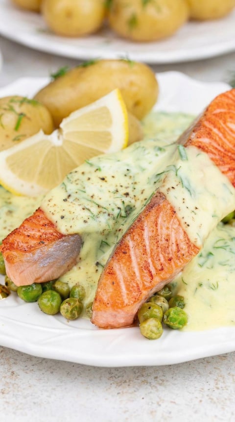 A piece of salmon with a lemon wedge on top.